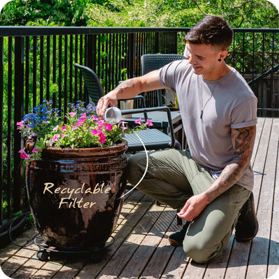 Person dumping their recycleable MINA Fluoride Filter into a pot outside#filtration-type_fluoride-removal