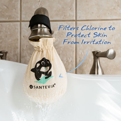 A Santevia Bath Filter hanging on a bath tub faucet with an arrow highlighting that it filters chlorine to protect skin from irritation.