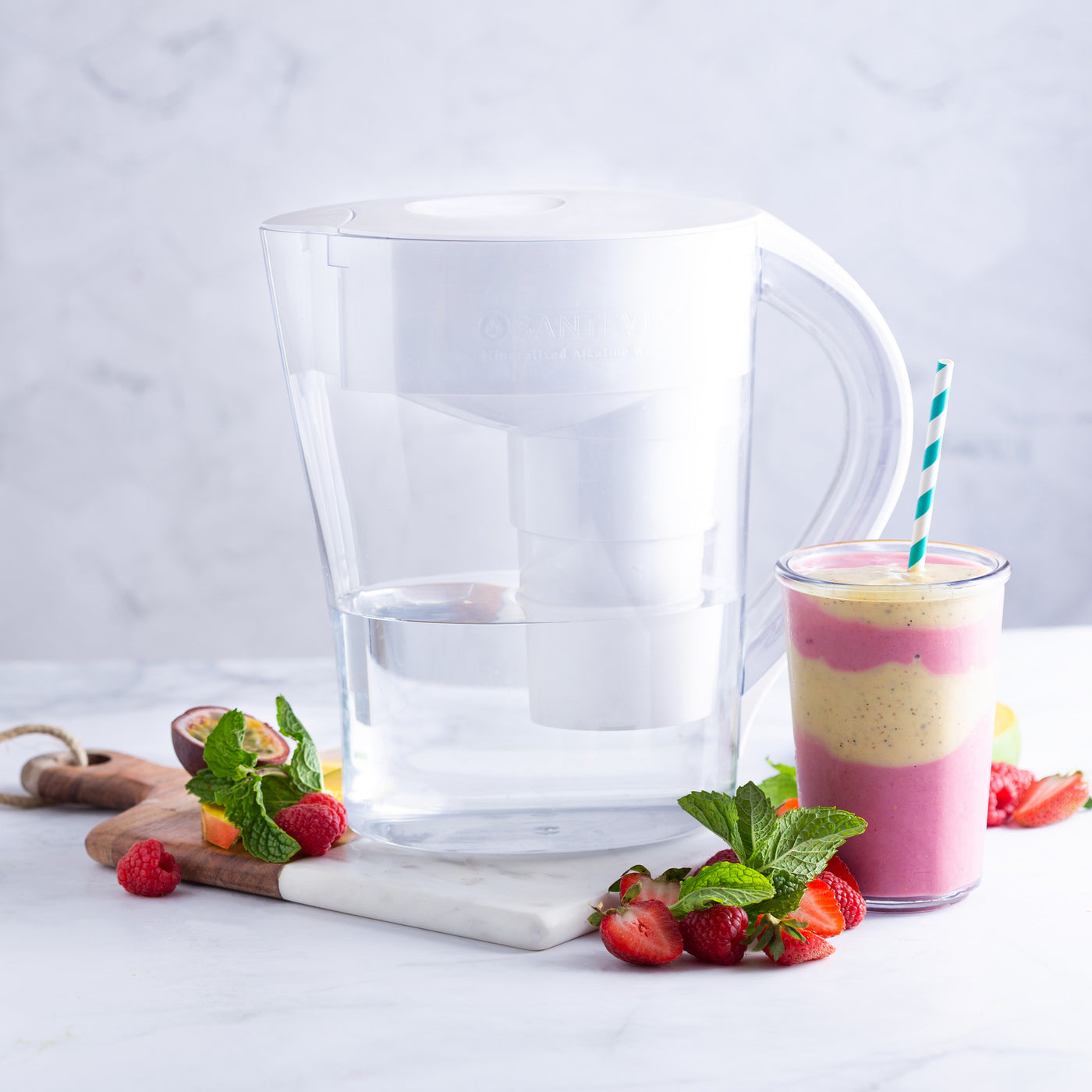The Santevia MINA Alkaline Pitcher with a strawberry, passion fruit, and strawberry alkaline smoothie#colour_white